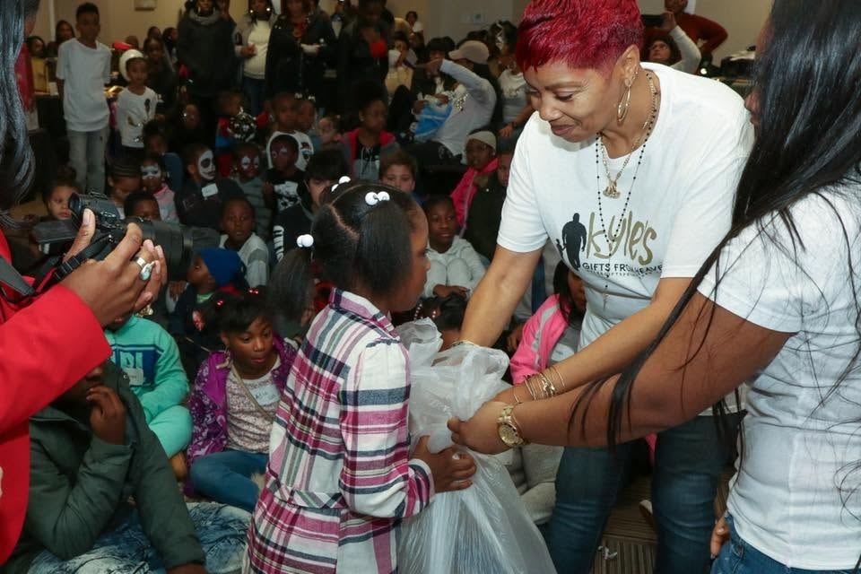 Kyle's Gifts from Heaven community event — volunteers giving gifts to children